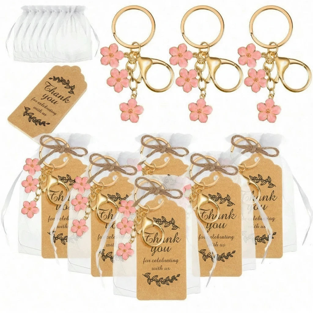 Giftplug cherry blossom keychains with pink enamel petals, gold-tone finish, organza bags, and thank you tags.