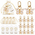Giftplug butterfly keychain party favors with gold-tone metal charms, organza gift bags, and thank you tags.