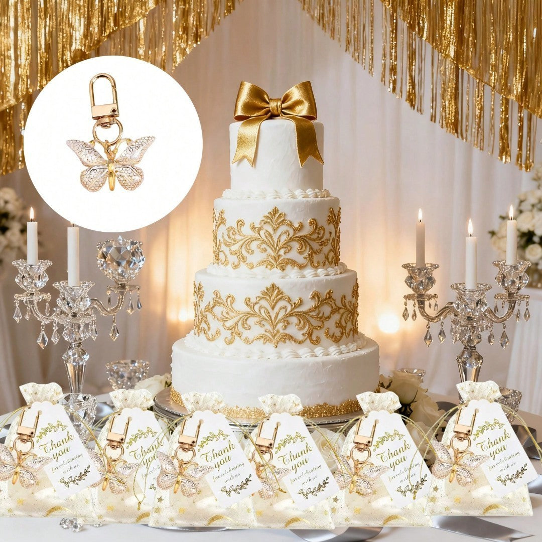 Giftplug gold butterfly keychains in organza pouches with thank you tags displayed before a tiered wedding cake.