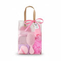 Giftplug pink beauty essentials gift set featuring a hairbrush, bath sponge, and makeup tools in a transparent bag.