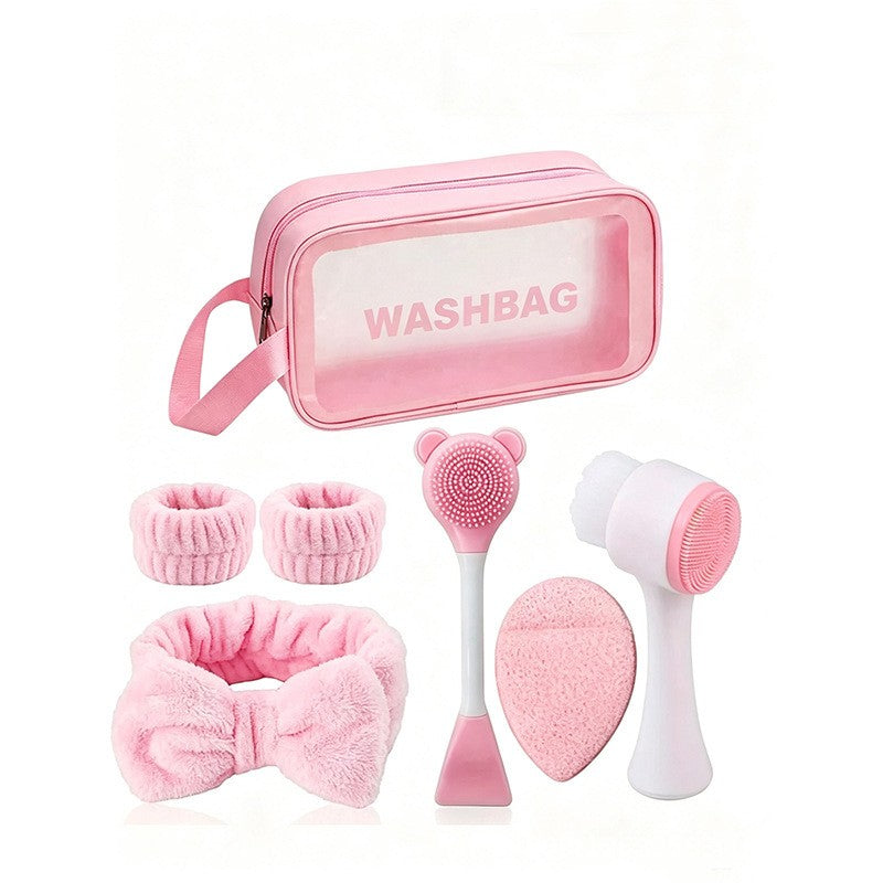 Giftplug 6-piece pink skincare set with plush bow headband, wristbands, cleansing brushes, and transparent washbag.