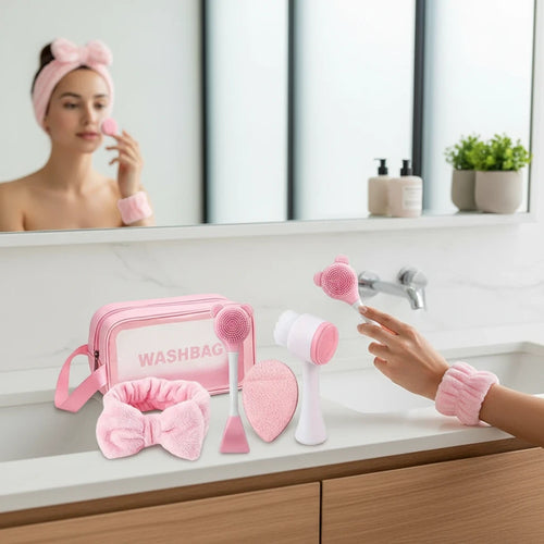 Giftplug 6-piece pink skincare set with bow headband, wristbands, cleansing brushes, and a transparent washbag.