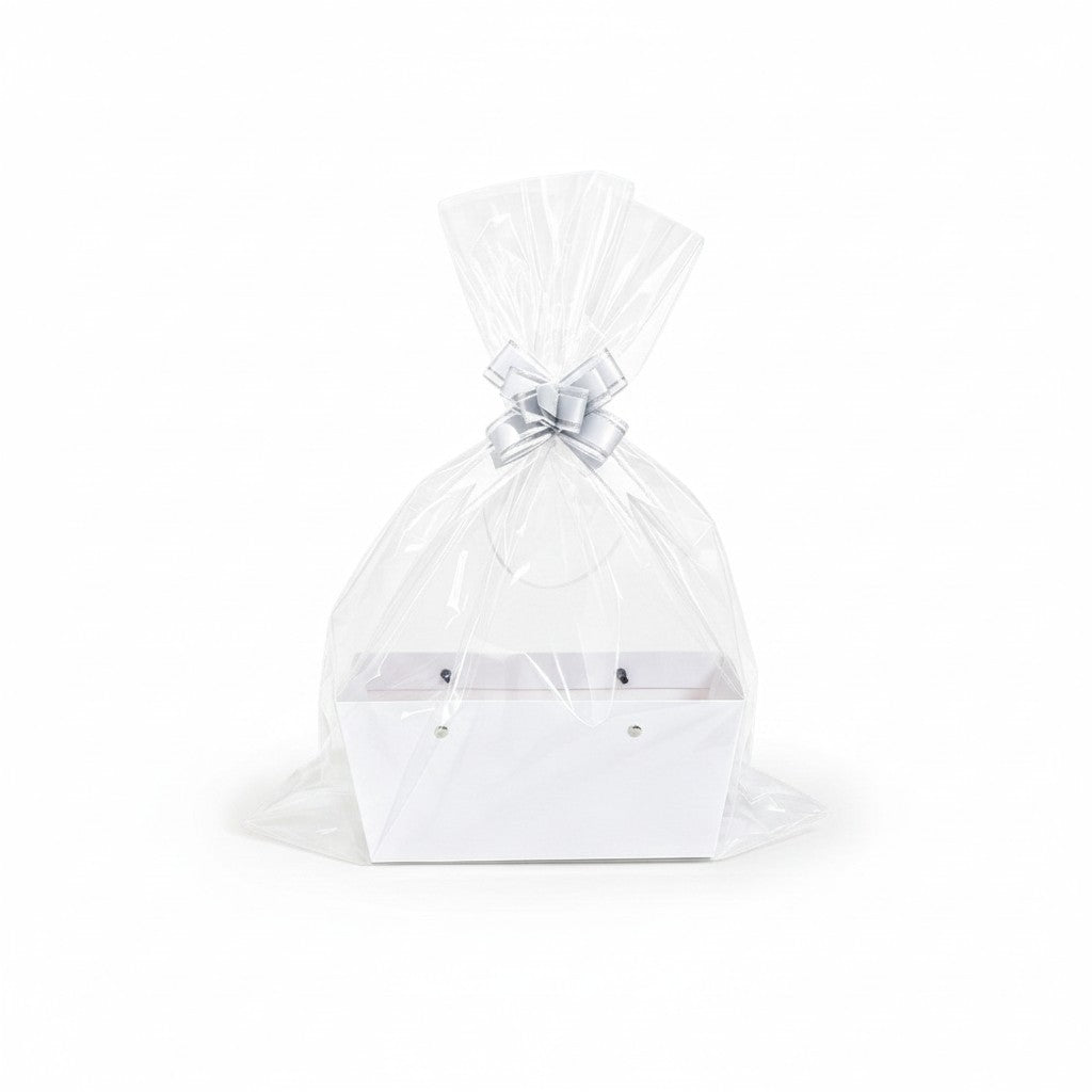 Giftplug white decorative gift basket with clear cellophane wrapping and a decorative silver bow on a white background